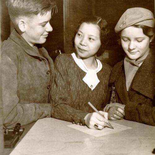 [Students studying banking at an office of Anglo California National Bank]