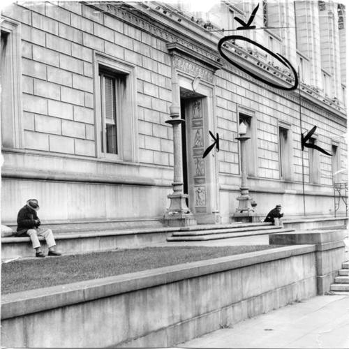 [People sitting on ledge along south wall of Main Library]