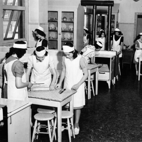 [Students from Girls High School baking in the food laboratory]