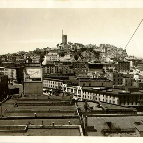 [View of Coit Tower, while under construction, from a rooftop near Columbus Avenue]