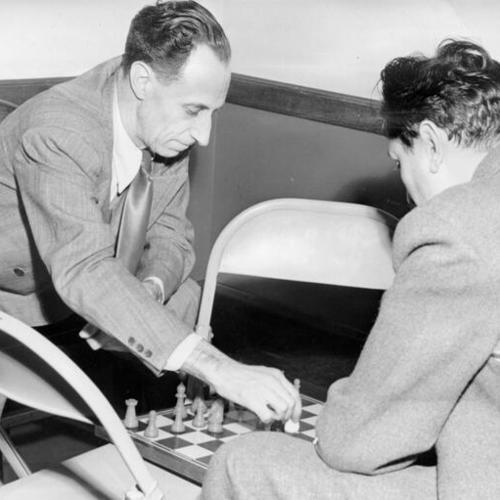 [Waiting for the jury to decide whether he is guilty or innocent of perjury and conspiracy, Harry Bridges longshore leader, whiles away the hours playing chess with his physician, Dr. Asher Gordon]