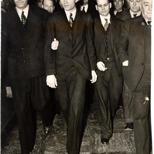 [James Lucas and Rufus Franklin, convicts who made a failed escape attempt from Alcatraz Prison, being led to courtroom to hear verdict in trial]