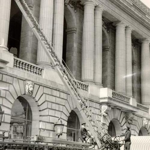 [Firemen cleaning the outside of the War Memorial Veterans Building]
