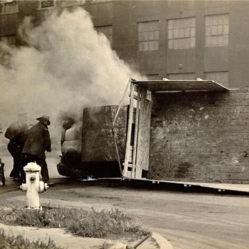 [Firemen extinguishing truck fire during strike of 1934]