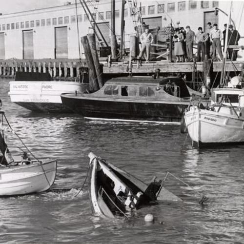 [Submerged boat being pulled out of the water at Fisherman's Wharf]