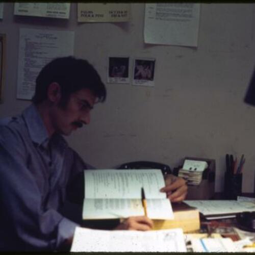 Roberto Esteves working at his desk in the Presidio Branch Library
