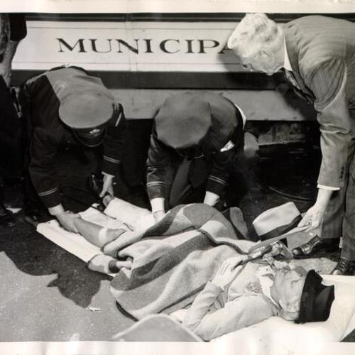 [Anna Davis receiving first aid after her right leg was nearly severed by the wheels of a cable car]