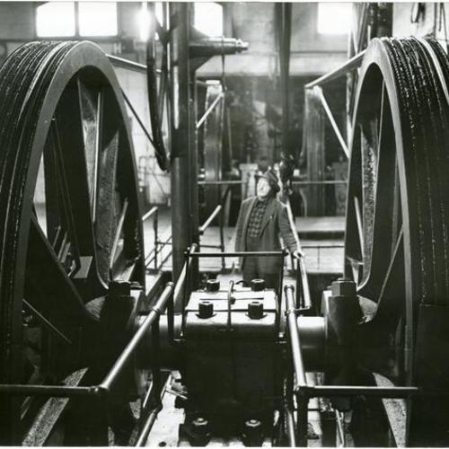 [V. V. Henderson inspecting machinery in the cable car barn at California and Hyde streets]