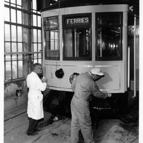 [Workers painting Municipal Railway streetcar number 1]