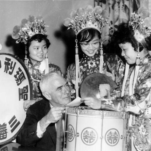 [Three members of the St. Mary's Chinese Girls Band with an unidentified man]