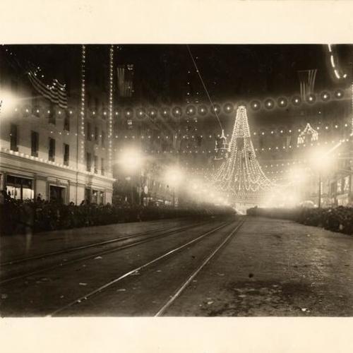 [Intersection of Market and Third streets, where 25,000 colored lights were suspended to form a gigantic bell, Portola Festival, October 19-23, 1909]