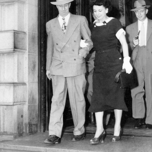 [Harry Bridges leaving Federal Building with his wife Nancy]