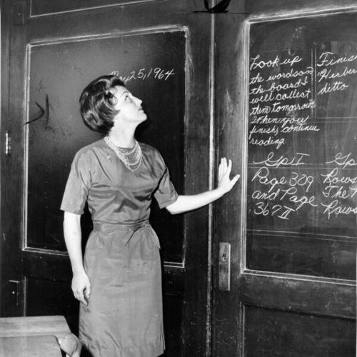 [Burnett School teacher Lois Vonzell showing thin folding door separating her class from adjoining one]