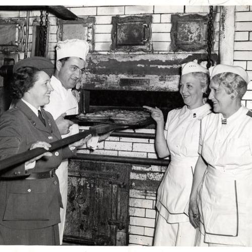 [Mrs. David Huenergardt, Pastry Chef Ernie Wenger, Mrs. Sydney Weisbaum and Mrs. Arnold Pastorius providing apple pies for the AWVS canteen]