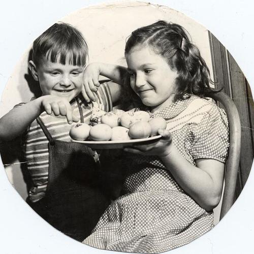 [Two children with a plate of Easter eggs at Edgewood Orphanage]