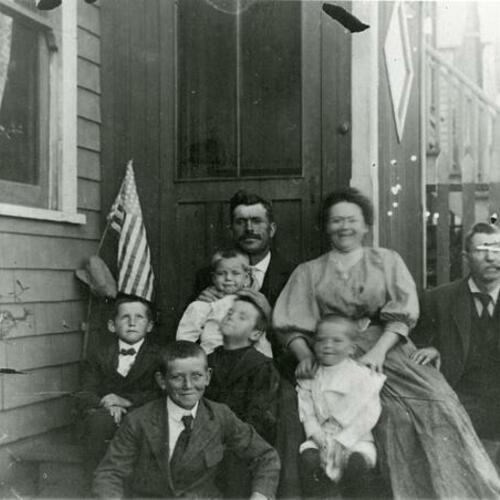 [Portrait of Cameron family in front of their home]