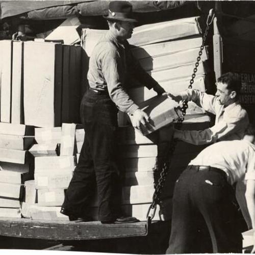 [Workers unloading a truck at end of strike at retail stores]