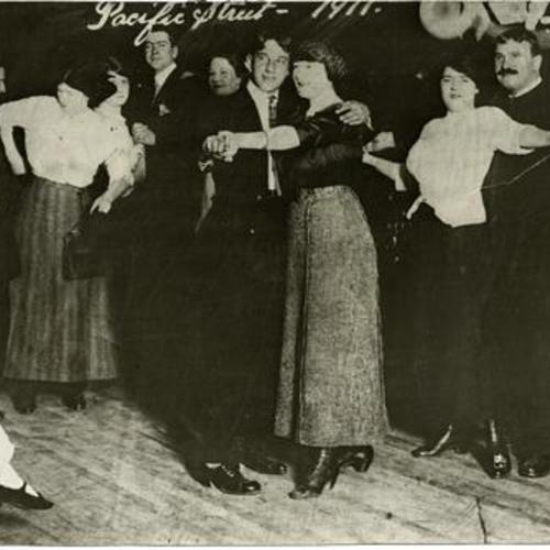 [People dancing inside Spider Kelly's bar room on Pacific Street in the Barbary Coast district]