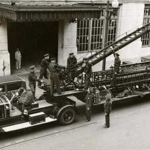 [Group of firemen with an old aerial ladder truck at Engine 3]