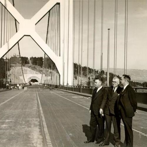 [Bridge engineers Charles E. Andrew, C. H. Purcell and Glenn Woodruff inspecting the West Bay crossing of the San Francisco-Oakland Bay Bridge]
