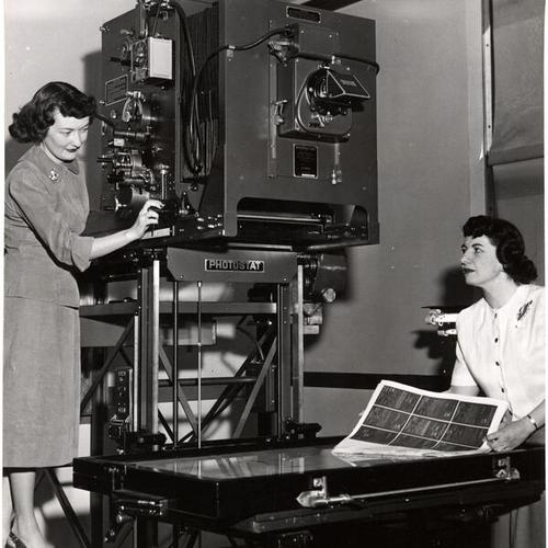 [City workers Cecile Peters and Josephine Lundwall with a photostat machine in the San Francisco County Clerk's Office in City Hall]