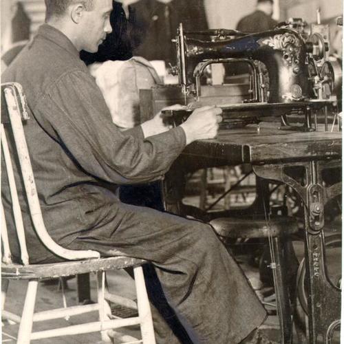 [Army prisoner working at a sewing machine on Alcatraz]