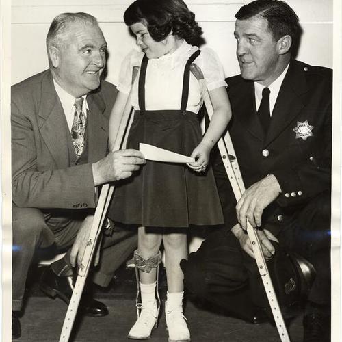 [Officer James J. McGovern (left) with Officer Joseph J. Cassidy (right), and daugher Christine Cassidy (center)]