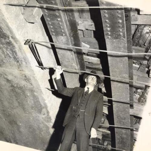 [Thomas Connelly, tunnel engineer, inspecting inside the tunnel on Yerba Buena Island during San Francisco-Oakland Bay Bridge construction]