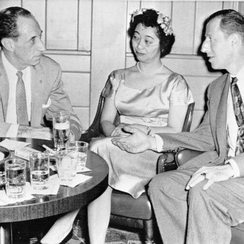 [Harry Bridges and his fiancee, Noriko Sawada talk over their problems with Attorney Samuel Francovich (right)]