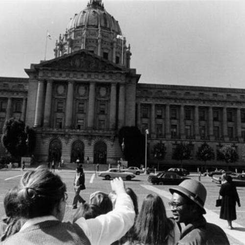 [Group of people on a tour of Civic Center Plaza]