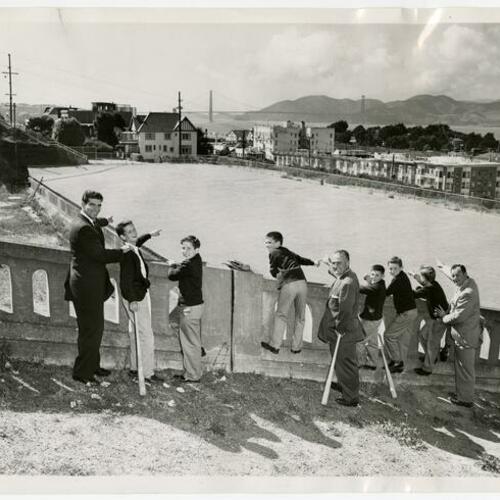 Major League athletes (left to right) Nini Tornay, Dario Lodigiani, and Fred Scolari visiting the Russian Hill reservoir with a group of North Beach Little Leaguers