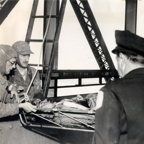 [Rescue crew removing painter William Shaw from the San Francisco-Oakland Bay Bridge after he was gravely injured when his head was caught between a beam and a moving scaffold]
