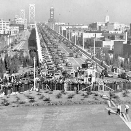 [Spectators and parade of automobiles celebrating opening day of the San Francisco-Oakland Bay Bridge]