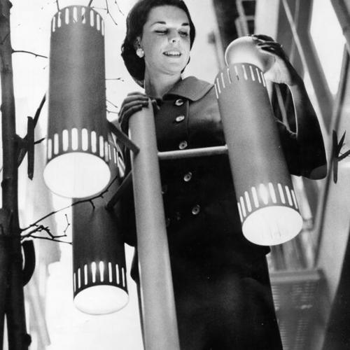 [Joan Brougham of Saks Fifth Avenue helping to install new lights on Maiden Lane]