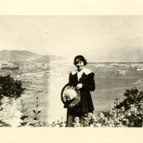 [Unidentified woman posing for a photograph in Visitacion Valley]