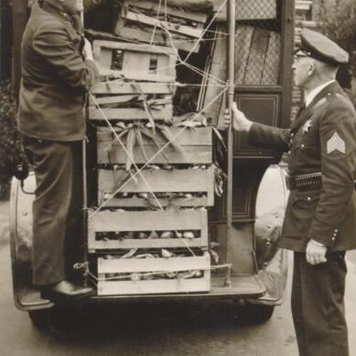 [Police officers transporting donation to Little Sisters of the Poor during dock strike]