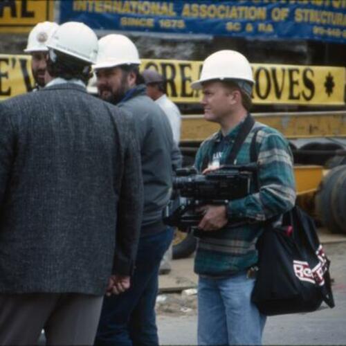 [Dave Schwabe (on the right), videographer, at the site of the new Main Library]