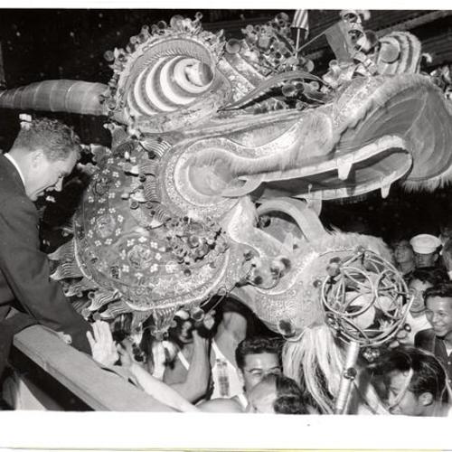 [Vice President Richard Nixon shaking hands with the dragon in the Double-Ten parade]