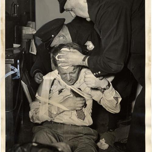 [Attorney George R. Andersen receiving first aid after being injured by two gunmen]