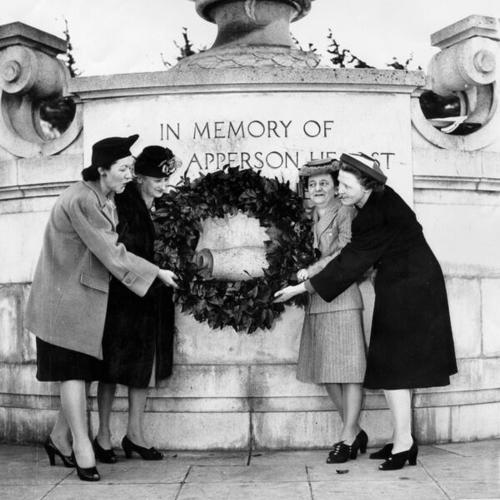 [Four unidentified women placing a wreath on the monument to Phoebe Apperson Hearst in Golden Gate Park]