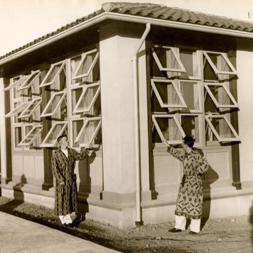 [Two patients standing outside of the tuberculosis unit at San Francisco City and County Hospital]