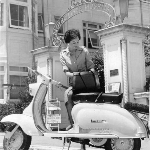 [Model June Smith demonstrating the practical uses of motor scooters for American housewives]