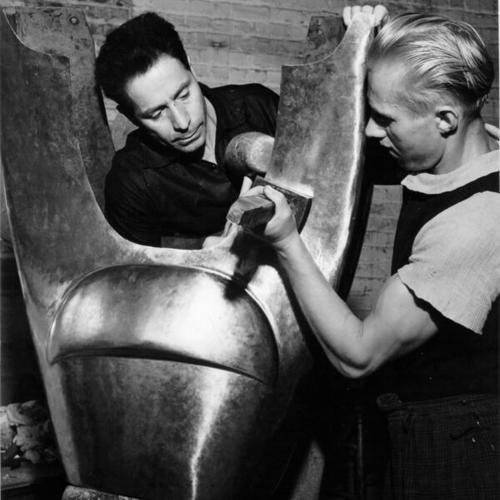[Sculptor Beniamino Bufano and assistant Fred Berge at work on statue of St. Francis]