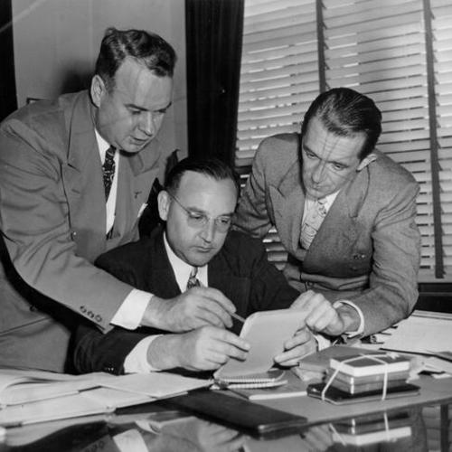 [District Attorney Edmund G. Brown (center) with Harry J. Neubarth (left) and unidentified man on right]