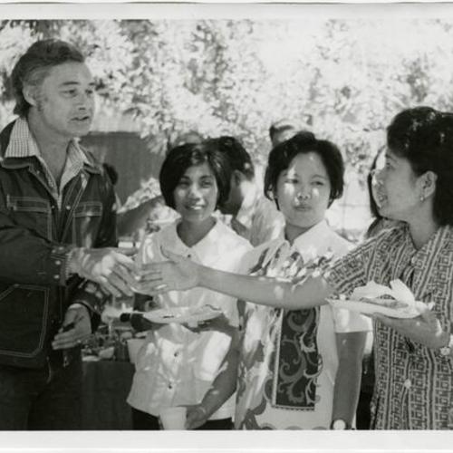 [George Moscone about to shake hands with a woman at the Gran Oriente Filipino Masonic picnic in South Park]
