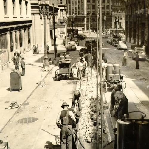 [Market Street Railway crew removing long-unused tracks from Post Street, between Montgomery and Kearny]