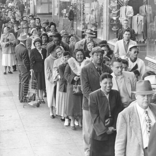 [Line of people waiting to buy New Zealand beef from Roy's Meats shop in the Crystal Palace Market]