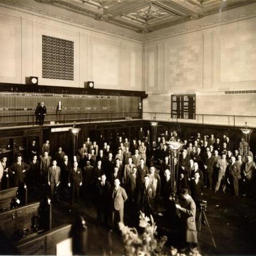 [Large group of people posing for a picture at the San Francisco Stock Exchange]