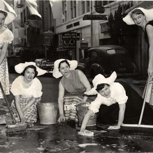 [Joyce Kerber, Mary O'Connor, Mildred Dalbey, Martha Trammell and Betty Ingalls scrubbing Maiden Lane in preparation for the annual spring festival]