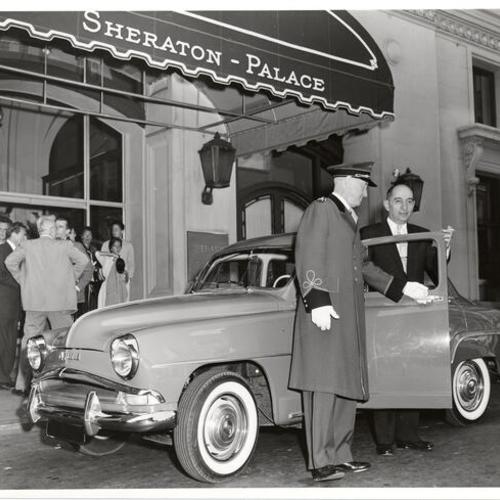 [Sheraton-Palace Hotel doorman Frank McCabe greeting A. M. Dolza outside the hotel]